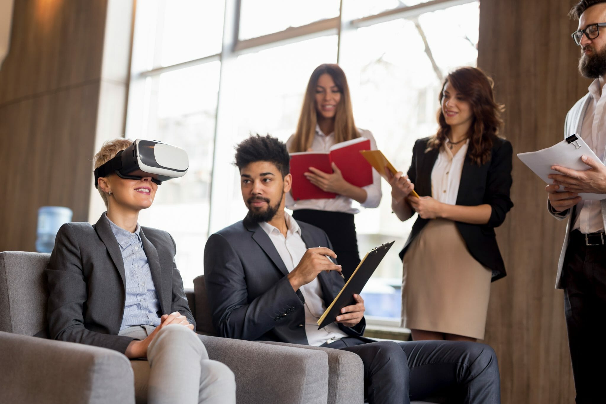 Group of people watching a coworkers VR demonstration