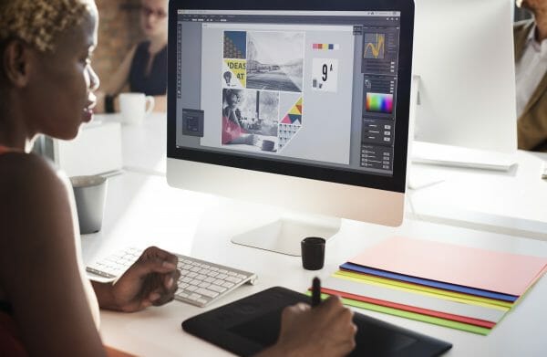 Woman working at a drawing tablet at computer