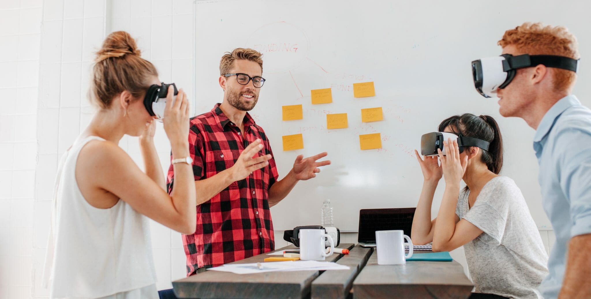 Group of people around a table testing VR headsets