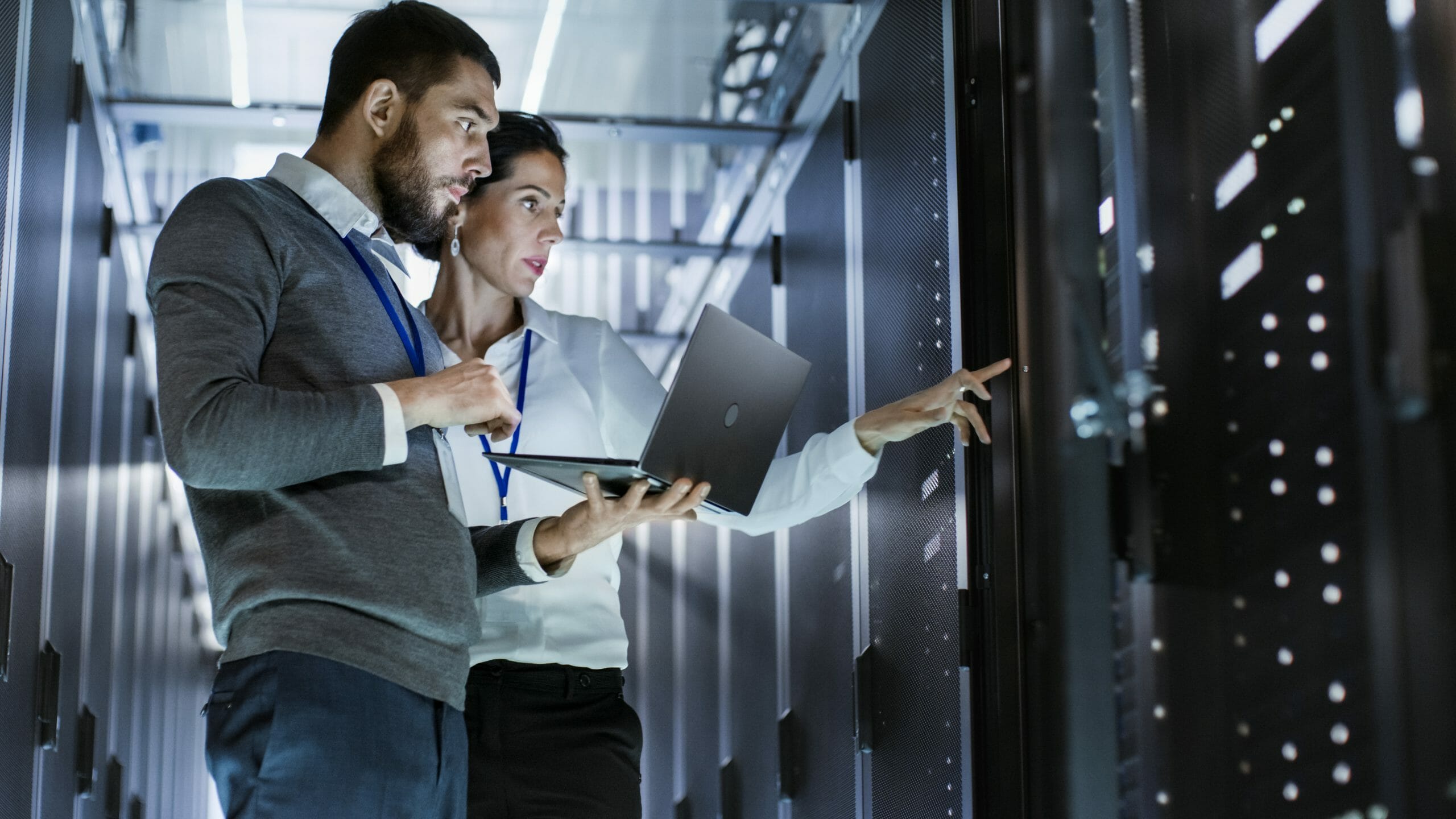 Two people in a server room